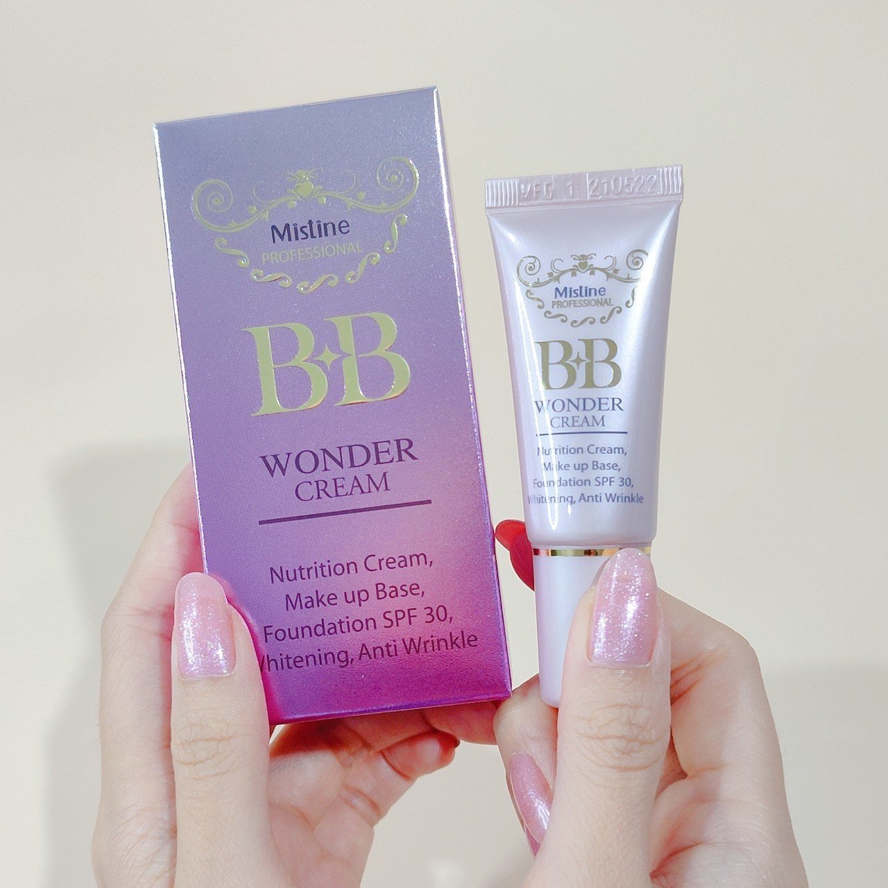 Mistine BB Wonder Cream tube and packaging held in hand beauty product view