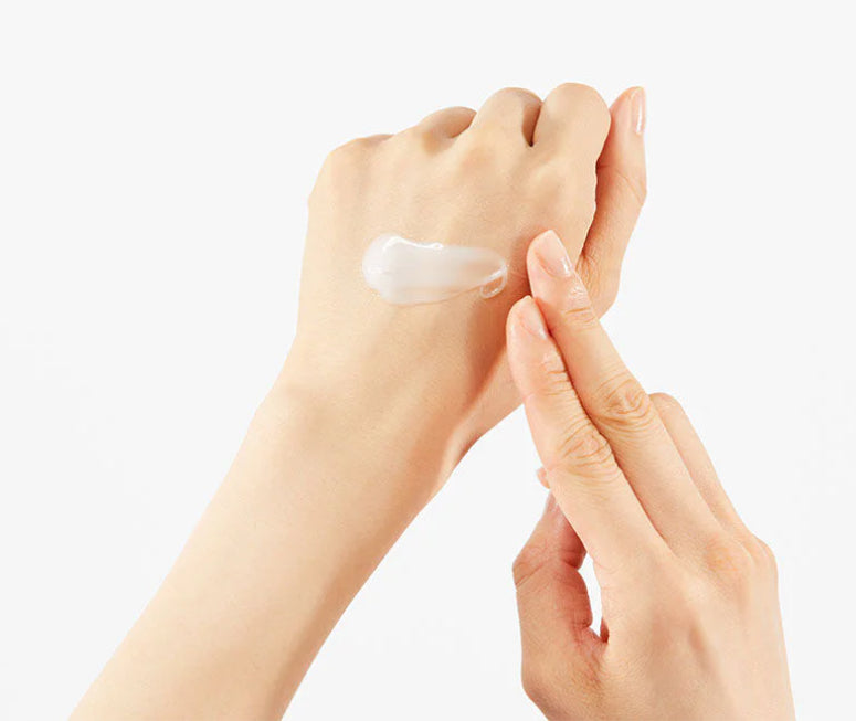 Applying COSRX Advanced Snail Mucin 92 All in One Cream on hand skin