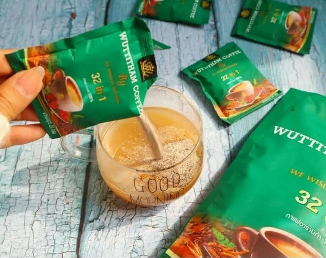 Wuttitham Instant Coffee sachets and cup of hot coffee on table with herbs