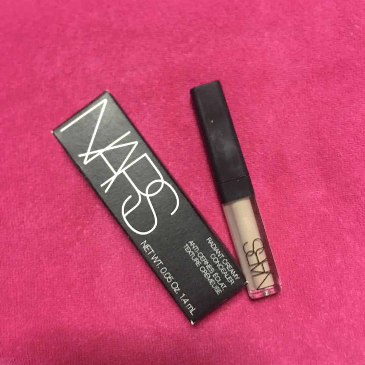 NARS Radiant Creamy Concealer Custard Vanilla in mini travel size packaging on pink background.