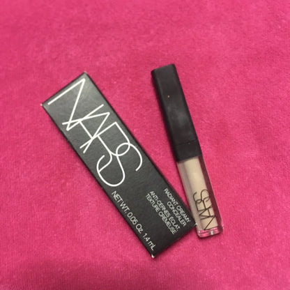 NARS Radiant Creamy Concealer Custard Vanilla in mini travel size packaging on pink background.