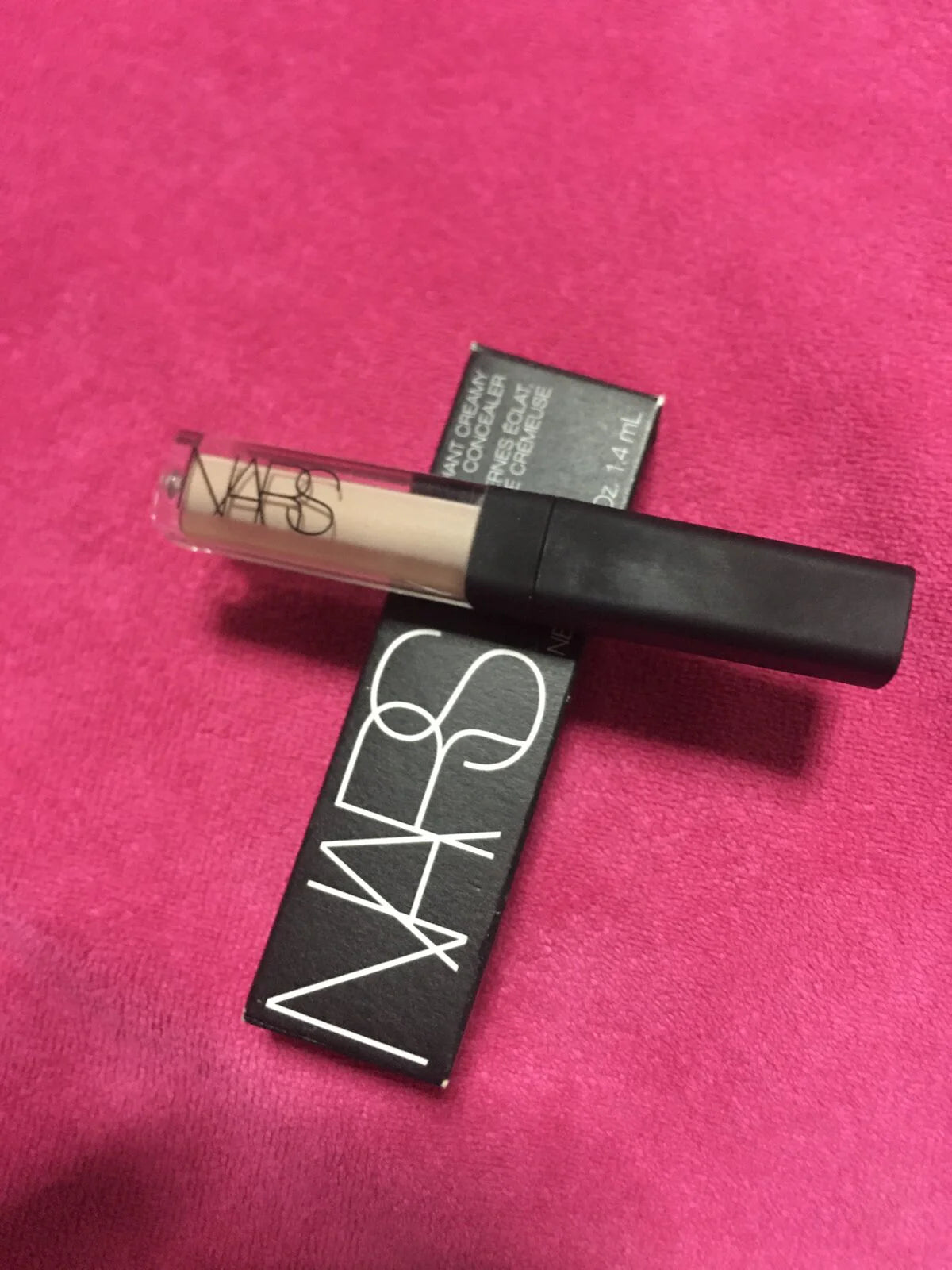 NARS Radiant Creamy Concealer Custard Vanilla 1.4 ml Mini Travel Size on a pink background.