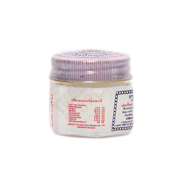 White Monkey Balm glass jar side view displaying product details and Thai script