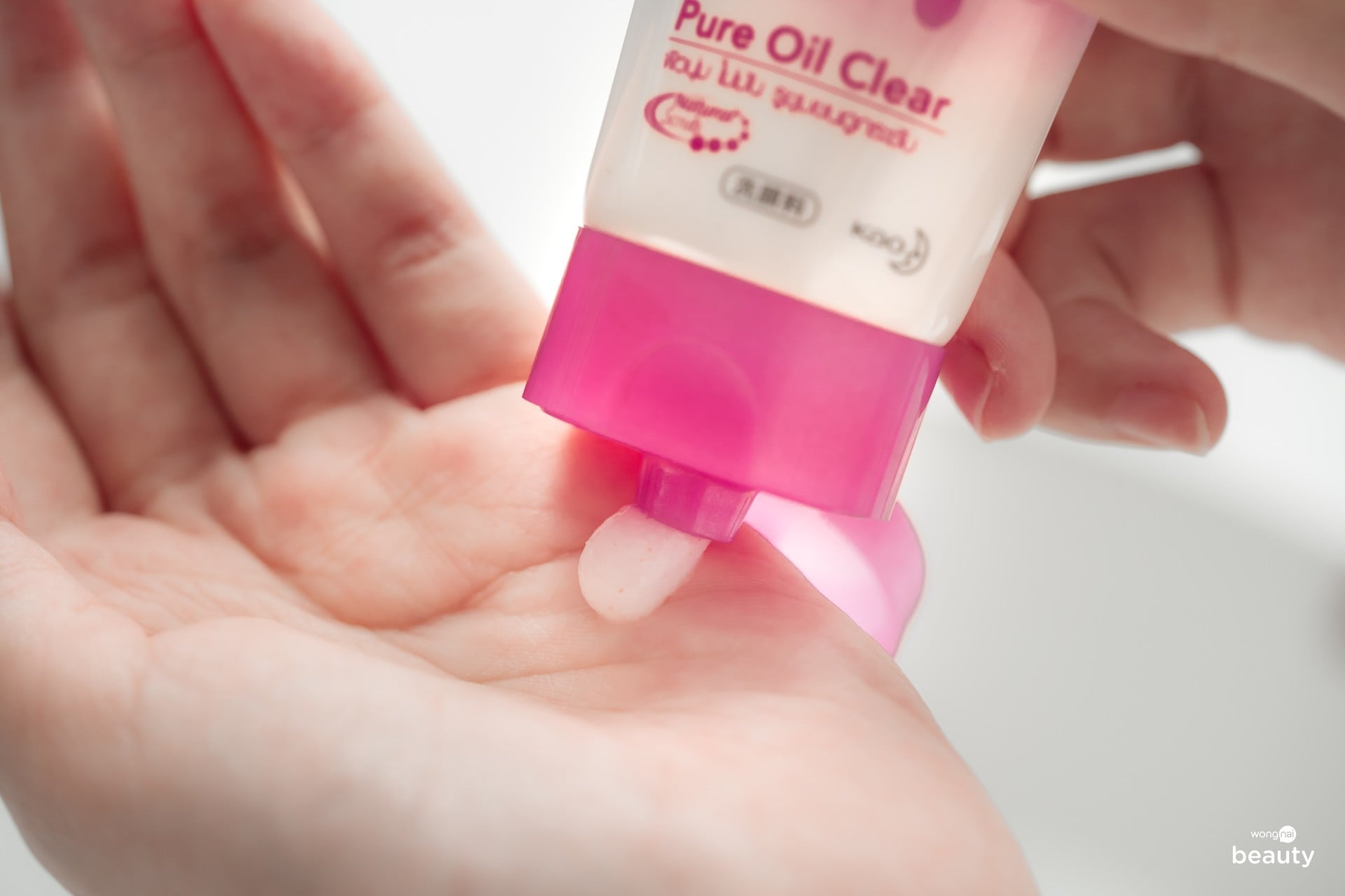 Biore Pure Oil Clear Foam facial cleanser tube held in hand showing texture