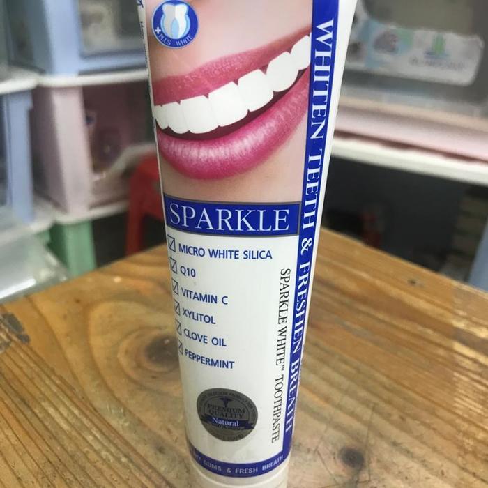 Sparkle Fresh White Toothpaste mint ice tube displayed on table real product photo