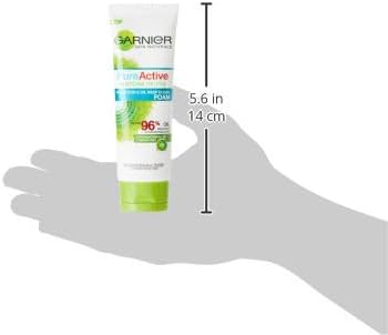 Hand holding Garnier Matcha DeTox Foam to show product size and scale