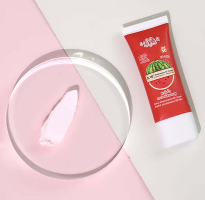 Sistar Watermelon EE Cream SPF50 PA++ Oil Control Facial Sunscreen in a red tube with a creamy texture on a glass dish