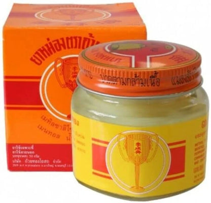 Golden Cup Balm Thai herbal yellow ointment in glass jar for sore muscles and stiffness