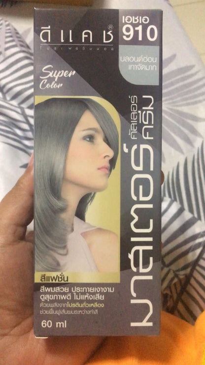Close up of Dcash Ash Gray Hair Dye 910 box held in hand displaying ash gray highlight model