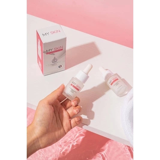 MY SKIN Glow Booster Serum dropper bottle with box on pink background and hand applying serum