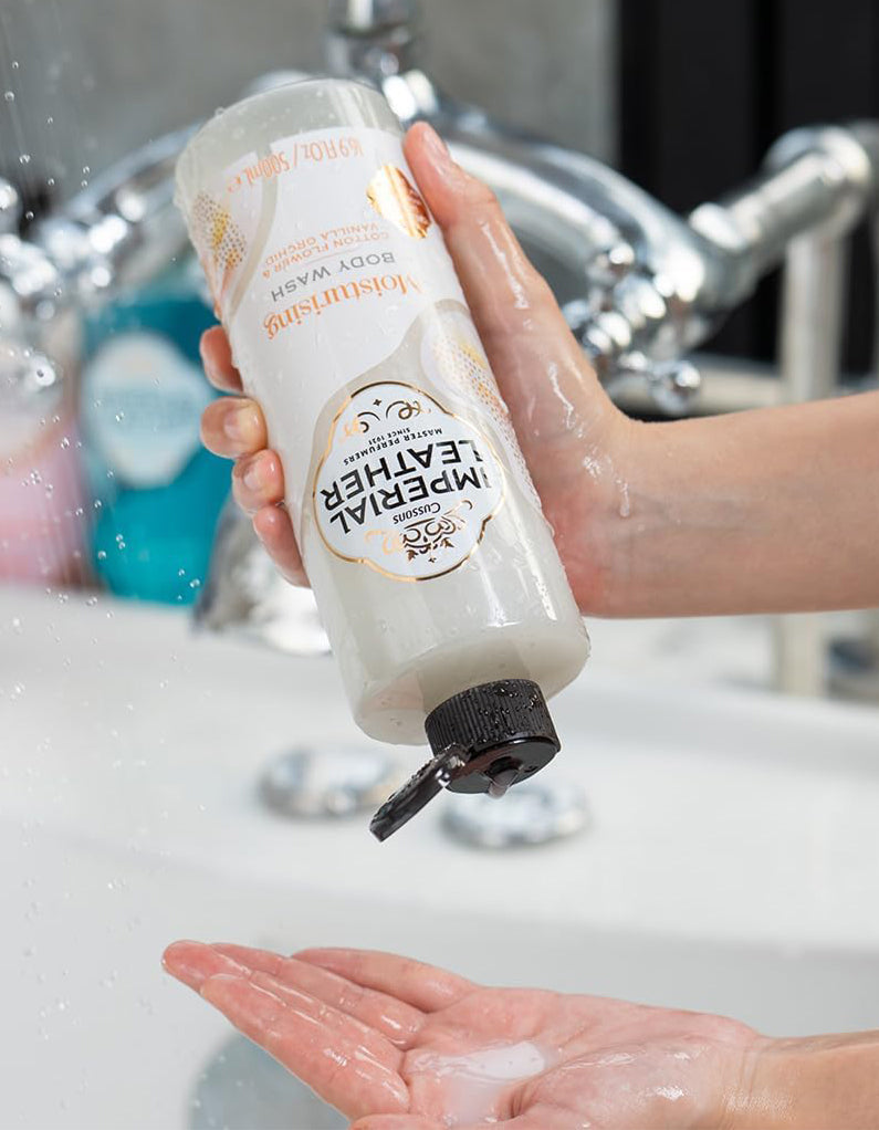 Imperial Leather Body Wash Cotton Flower & Vanilla Orchid pouring into hand, showcasing luxurious lather in a bath setting.
