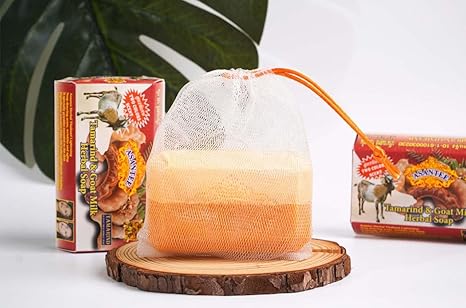 Asantee Tamarind Goat Milk Soap bar placed on a soap dish next to box for clean and natural skincare presentation