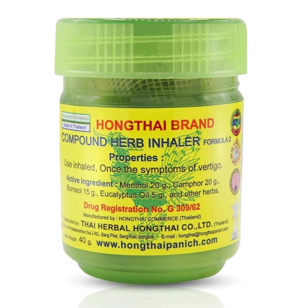 Close-up of Hong Thai Herbal Balm jar label with product information in yellow and red text.