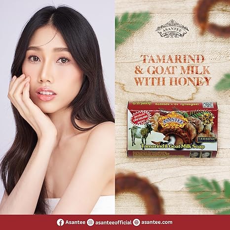 Model holding Asantee Tamarind Goat Milk Soap showing smooth bright skin after using the Thai herbal soap