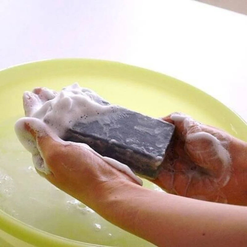 Person holding Pelican For Back Acne Soap with rich foam for deep cleansing and acne treatment.