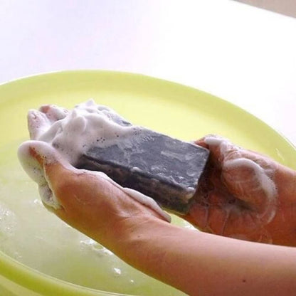 Person holding Pelican For Back Acne Soap with rich foam for deep cleansing and acne treatment.