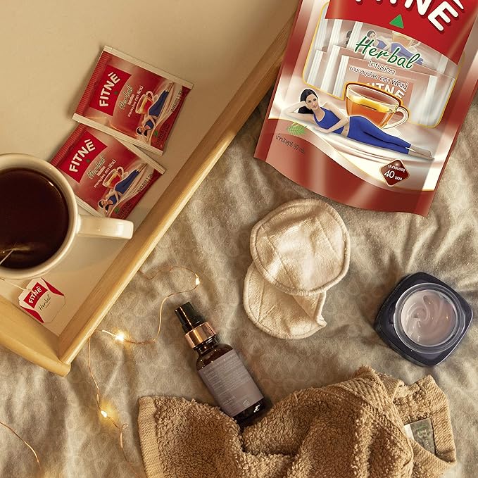 Fitne Herbal Slimming Tea 40 Bags lifestyle flat lay with tea cup and sachets on fabric
