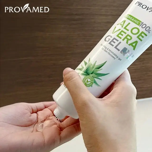 Hand squeezing lightweight clear gel from a Provamed Aloe Vera Gel tube