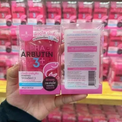 Alpha Arbutin Soap held in hand displaying front and back package on retail store shelf
