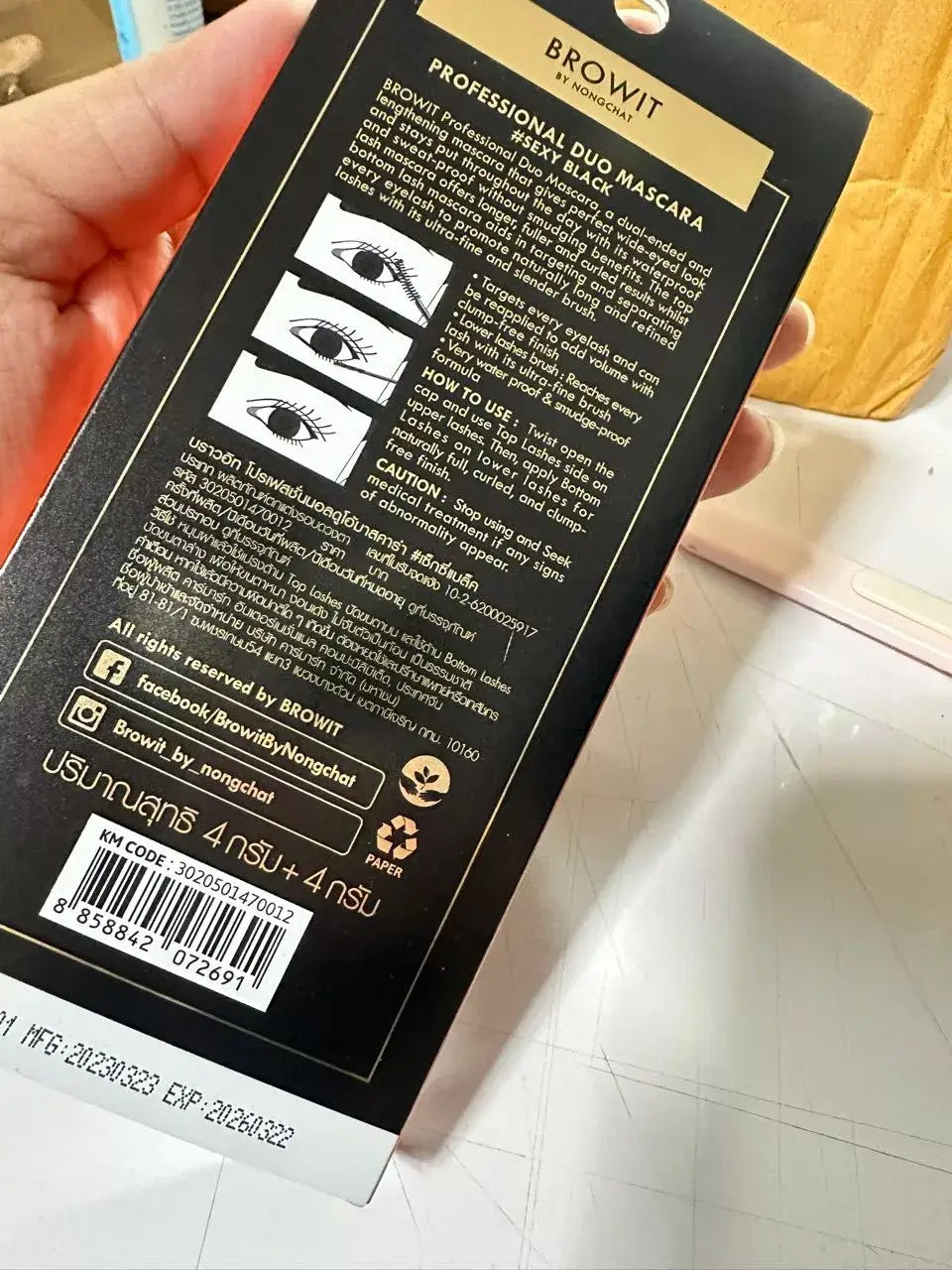 Close-up view of the detailed English and Thai text instructions on the back of the BROWIT Professional Duo Mascara packaging box.