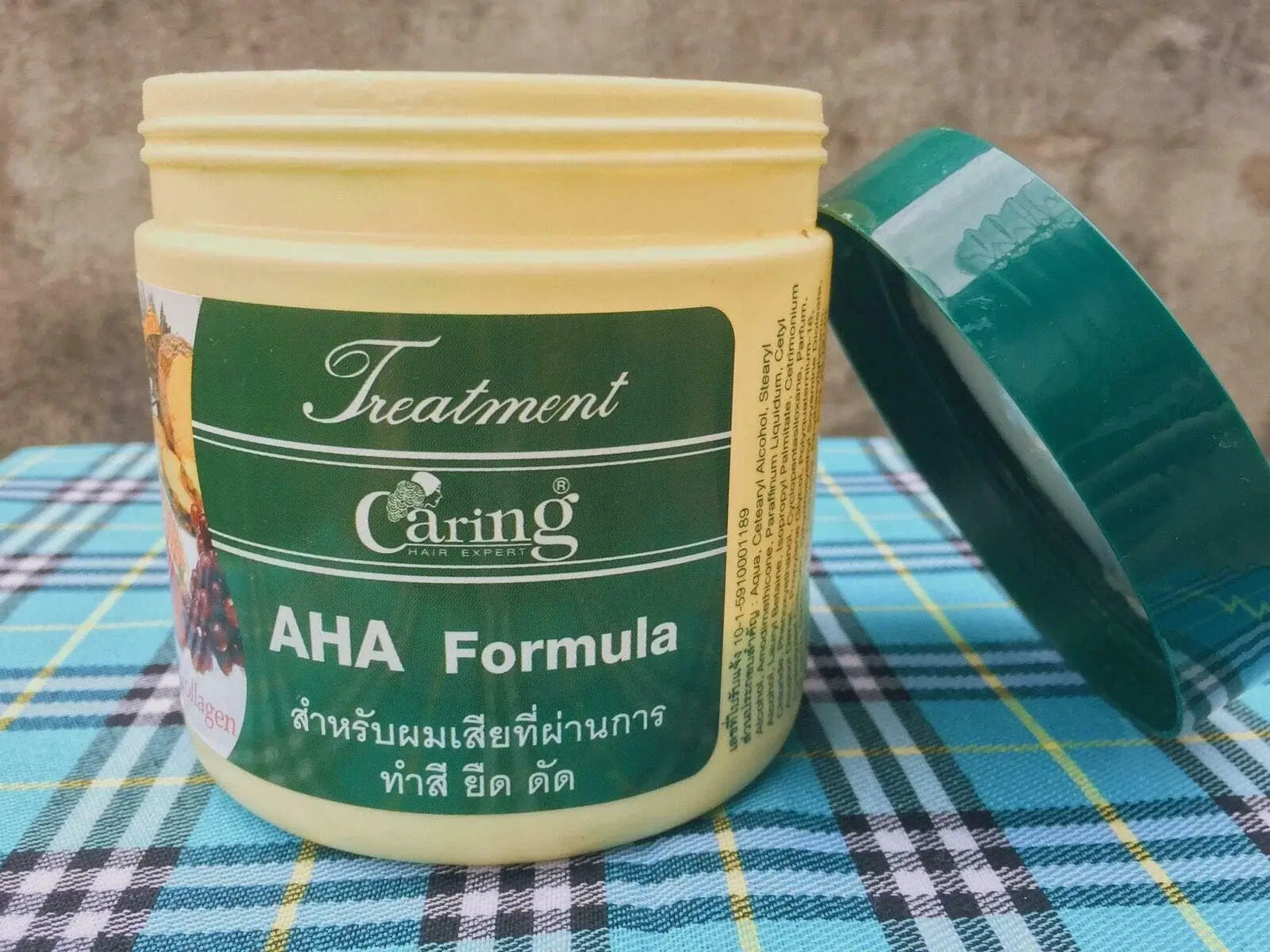 Caring AHA Hair Treatment nourishing hair mask jar with open lid on display