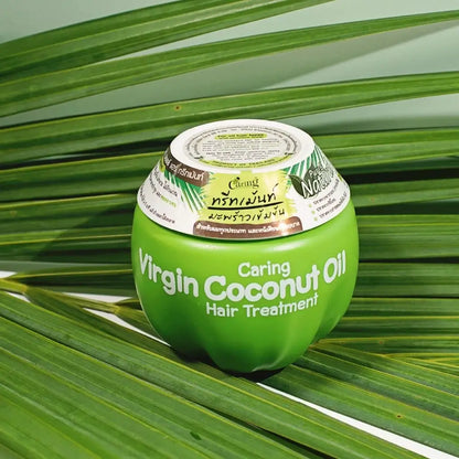 Caring Virgin Coconut Oil Hair Mask on green leaves, ideal for hair treatment and care, promoting smooth and shiny hair.