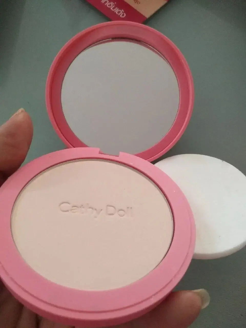 Cathy Doll CC Powder Pact open showing smooth powder and mirror, ideal for shine-free finish and makeup touch-ups.