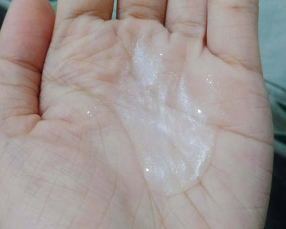 Cathy Doll Ready 2 White creamy texture shown on palm, showcasing its hydrating and brightening qualities.