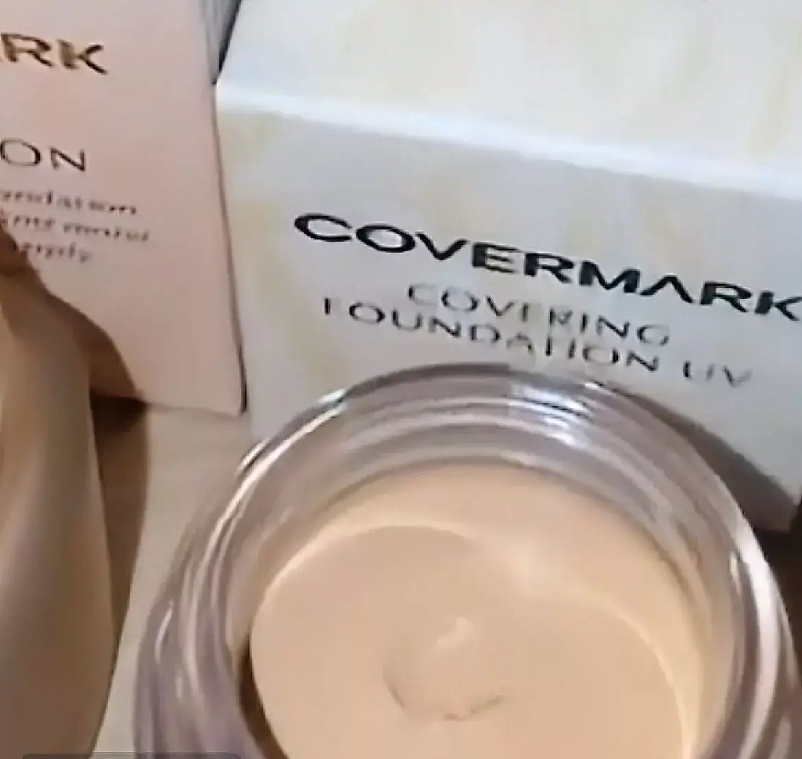 Covermark Foundation UV JQ creamy texture in jar beside Covermark packaging, showcasing high coverage waterproof foundation.