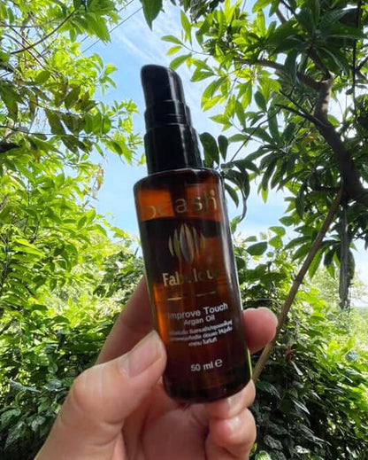 Dcash Fabulous Hair Serum Argan Oil 50ml bottle held outdoors showing product container