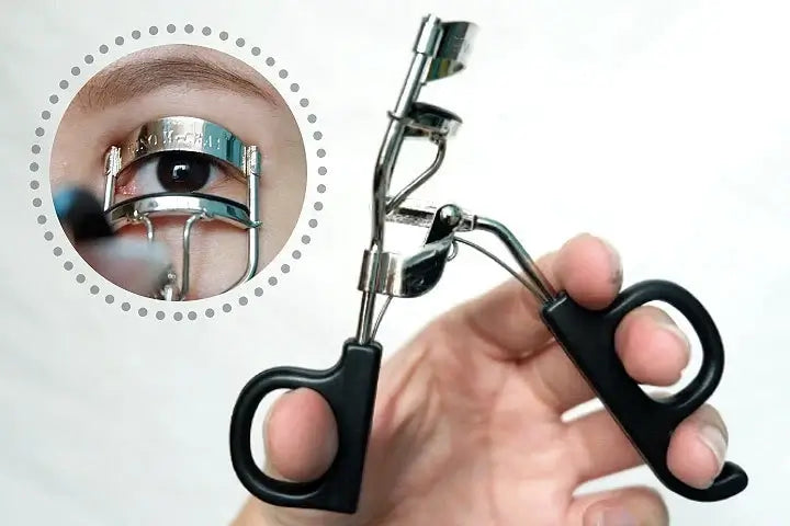 GINO McCRAY Eyelash Curler held in hand showing eye curling demonstration