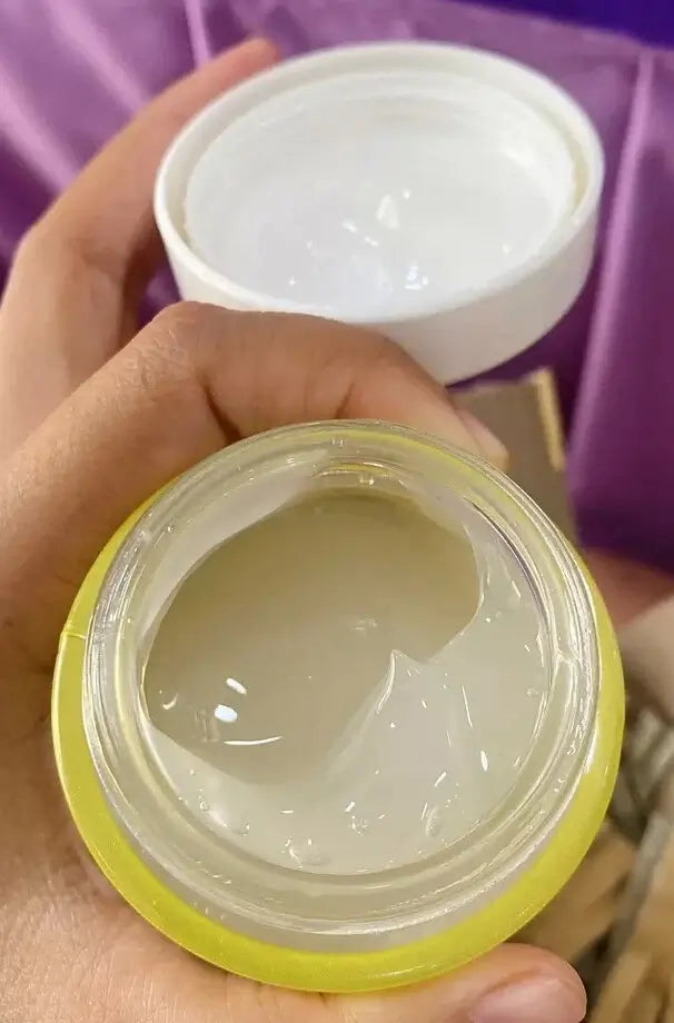 Hand holding the Garnier Vitamin C Water Gel jar showing the opened texture inside.