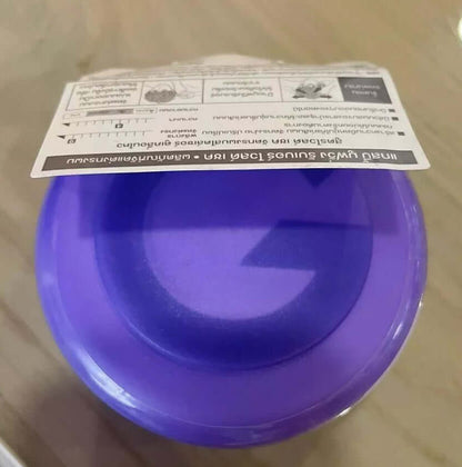 Gatsby Moving Rubber Wax purple container top view with retail paper tag on table surface