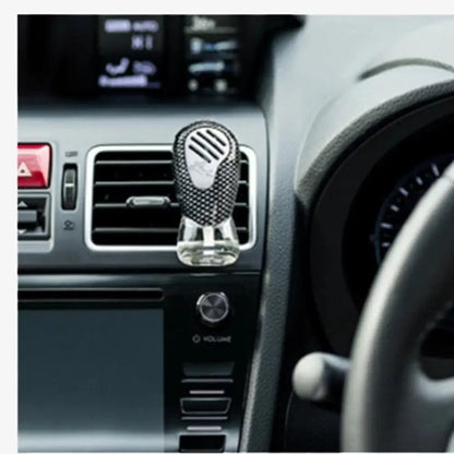 Close-up of Glade Sport Car Air Freshener Unit Clipped and Activated on a Car's AC Vent Dashboard