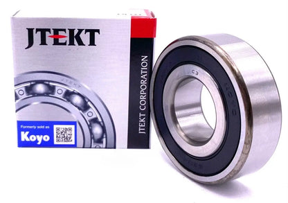 KOYO 6203-2RS Bearing displayed with JTEKT packaging, showcasing smooth rotation and rubber seal design.