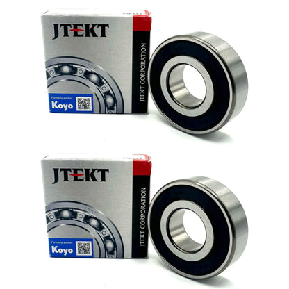 KOYO 6203-2RS Bearing featuring a rubber seal, in front of its packaging from JTEKT Corporation.