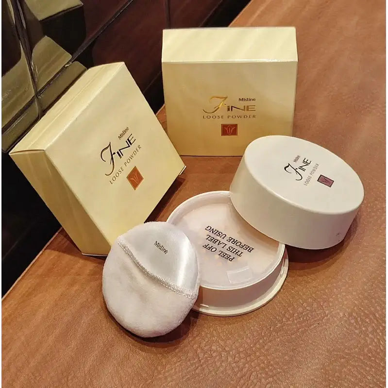 Mistine Fine Loose Powder in packaging with puff, showcasing a smooth makeup setting solution for flawless skin.