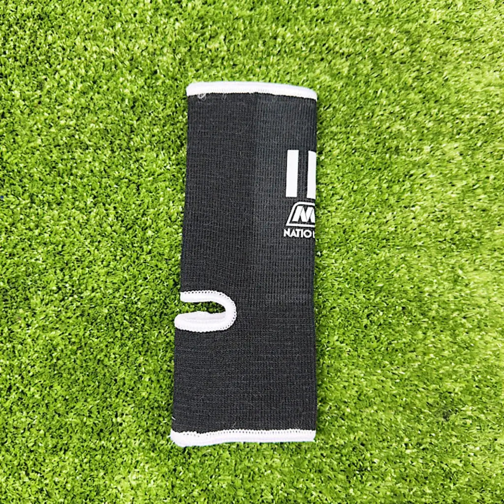 Nationman Ankle Guard support shown on grass background, ideal for Muay Thai and MMA athletes.