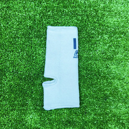 Nationman Ankle Guard support for Muay Thai, boxing, and MMA on green artificial turf.