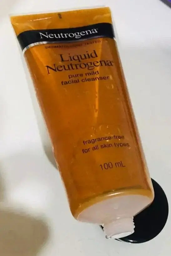 Neutrogena Pure Mild Cleanser tube opened with black cap showing dispenser opening