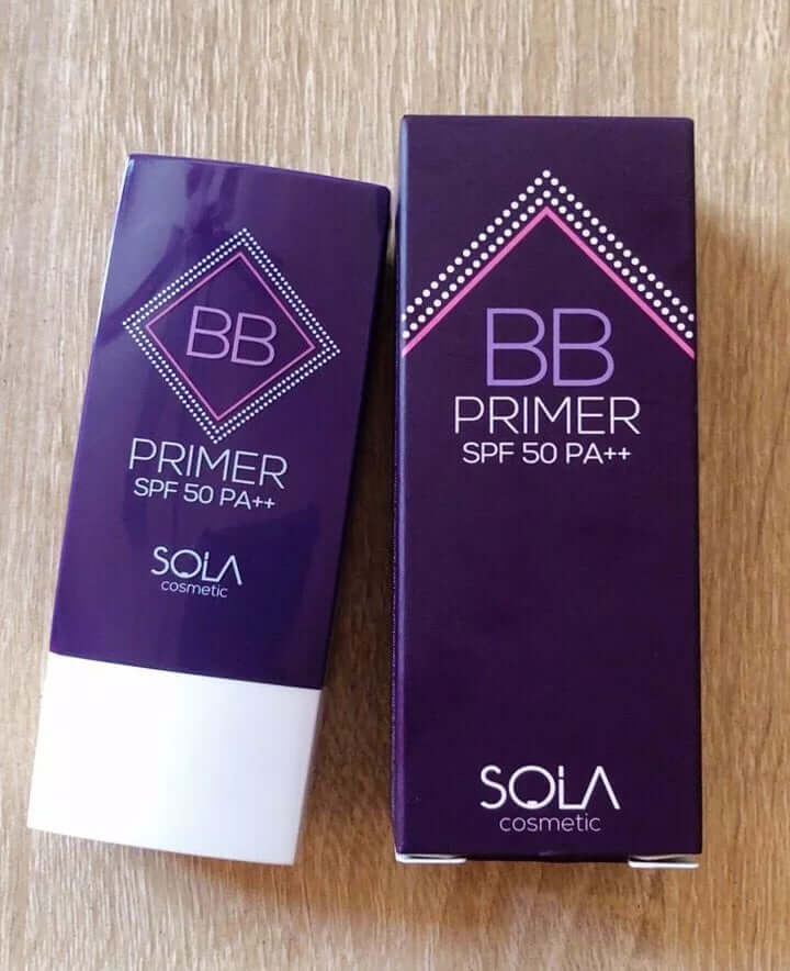 Real-world product shot of SOLA BB Primer in both sachet form and its corresponding purple product box, displayed together.