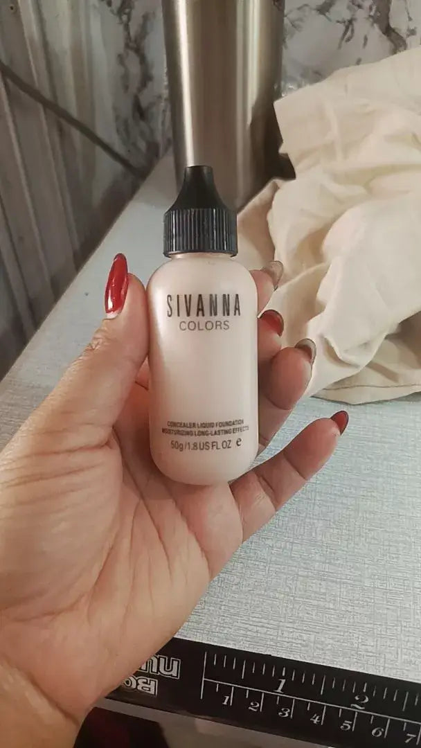Sivanna Colors Velvet Foundation Touch Concealer Liquid HF674 50ml held in hand, showcasing its smooth coverage and elegant packaging.