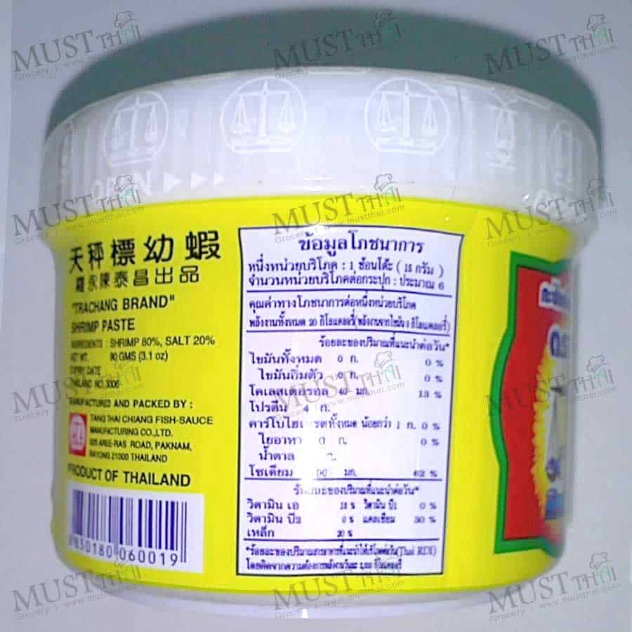 A close-up shot of the back of the Trachang shrimp paste jar, showing the nutritional information and ingredients list in Thai.