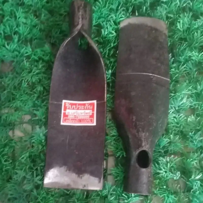 Two traditional Thai Spade Head Shovel metal tools showing different sides on a green textured background.