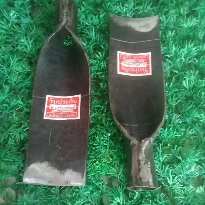 Front and back view of a Thai Spade Head Shovel steel blade with a red label sticker placed on a green artificial grass surface.