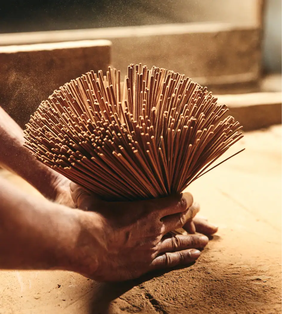 Noppamas Incense Sticks bundle being prepared, showcasing traditional craftsmanship in incense making.