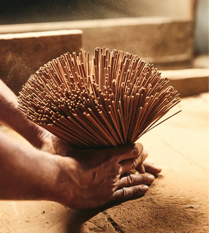 Noppamas Incense Sticks bundle being prepared, showcasing traditional craftsmanship in incense making.
