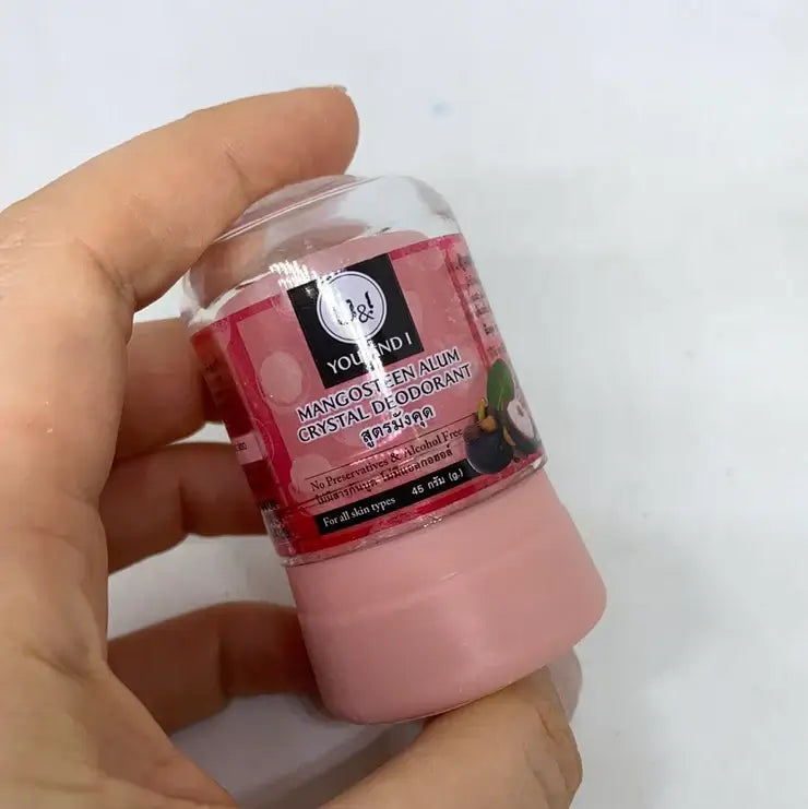 Hand holding U&I Alum Deodorant mangosteen crystal stick 45g