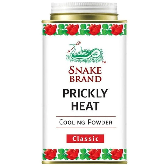 Snake Brand Classic Prickly Heat Cooling Powder 140g tin with floral design.