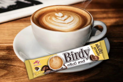 Birdy 3in1 Coffee Mix Powder Creamy Latte served hot in a cup with product sachets on table